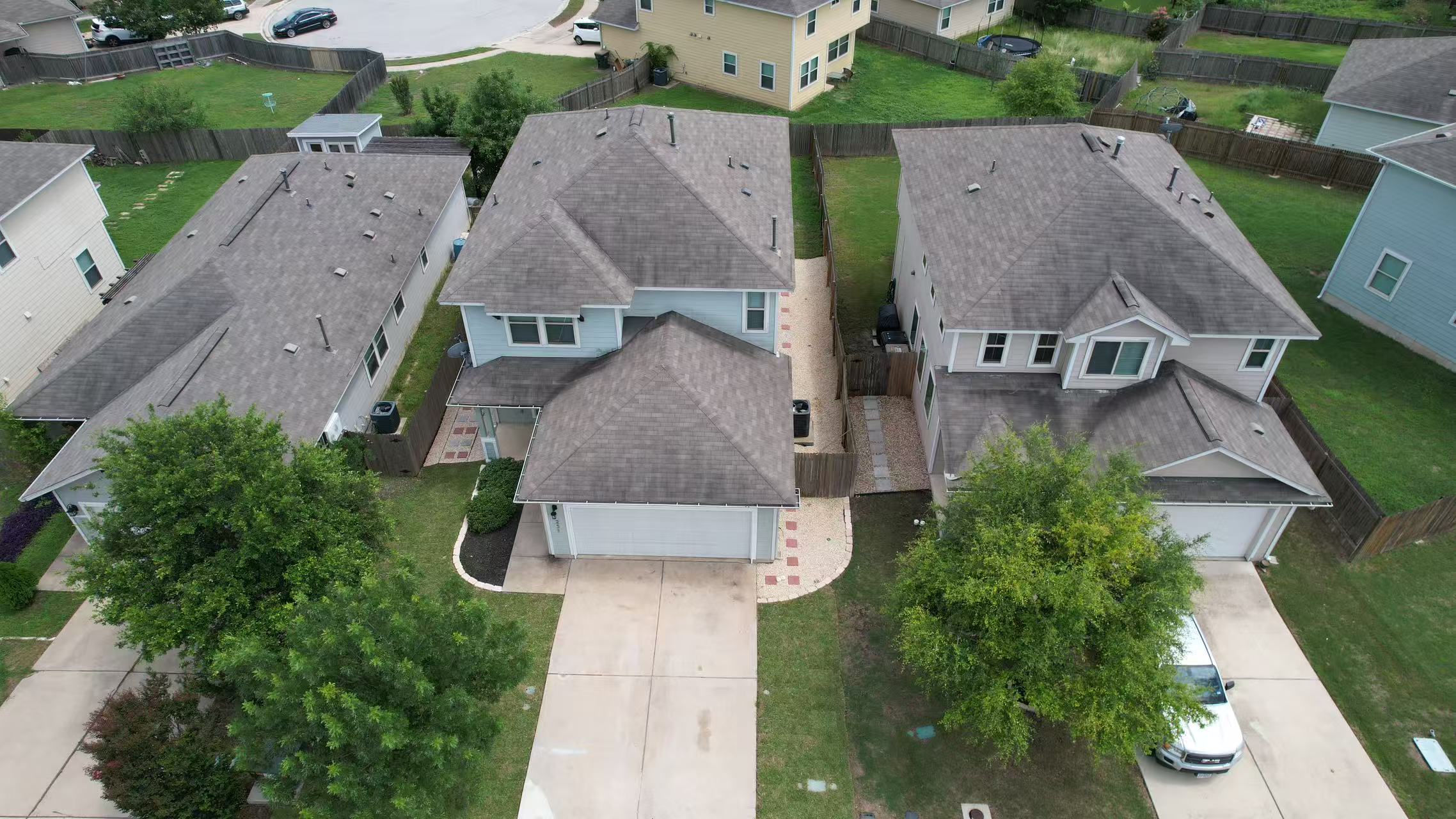 251 Triumph Road Buda, TX 78610 - Photo 21 of 26 An aerial view captures the architectural rhythm of adjacent homes and their neatly paved driveways.