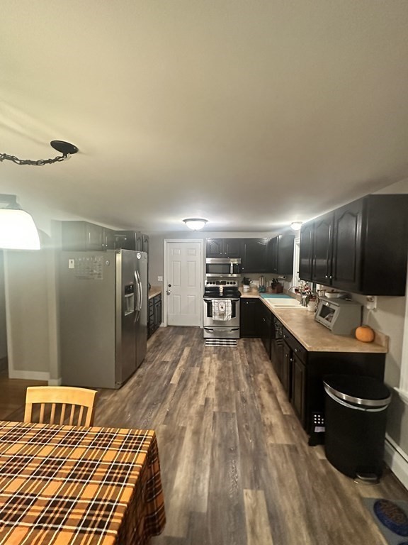4 Williams Road Sturbridge, MA 01566 - Photo 4 of 30 a kitchen with a sink and wooden floor