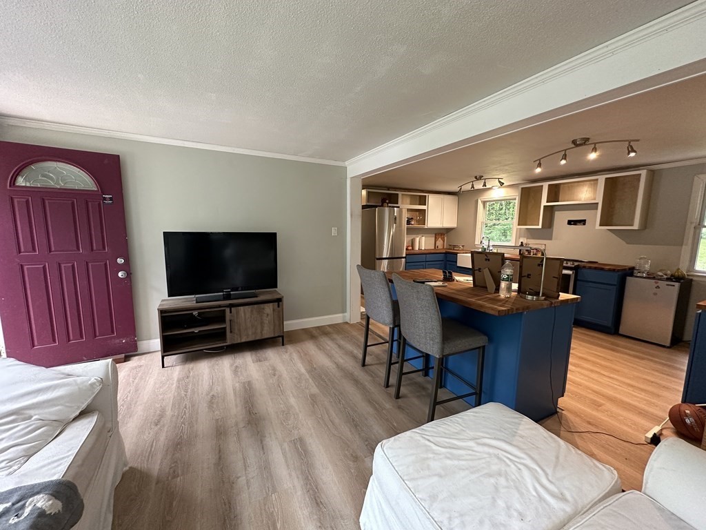 31 Harrington Road Charlton, MA 01507 - Photo 3 of 10 a living room with furniture and a flat screen tv