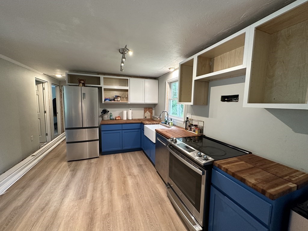 31 Harrington Road Charlton, MA 01507 - Photo 4 of 10 a kitchen with stainless steel appliances granite countertop a refrigerator and a stove