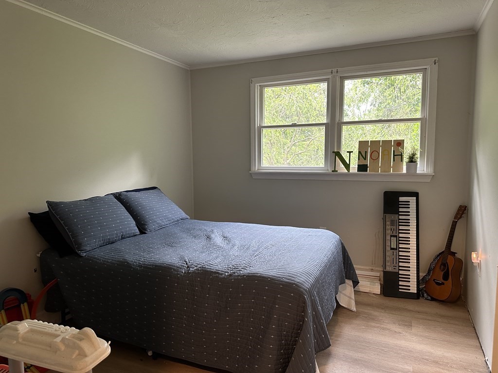 31 Harrington Road Charlton, MA 01507 - Photo 8 of 10 a bedroom with a bed and a large window