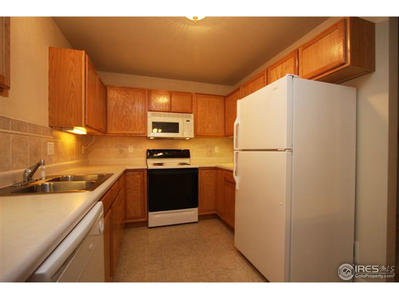 2621 Rigden Parkway, Unit C3 Fort Collins, CO 80525 - Photo 4 of 17 a kitchen with a refrigerator a stove a sink and dishwasher