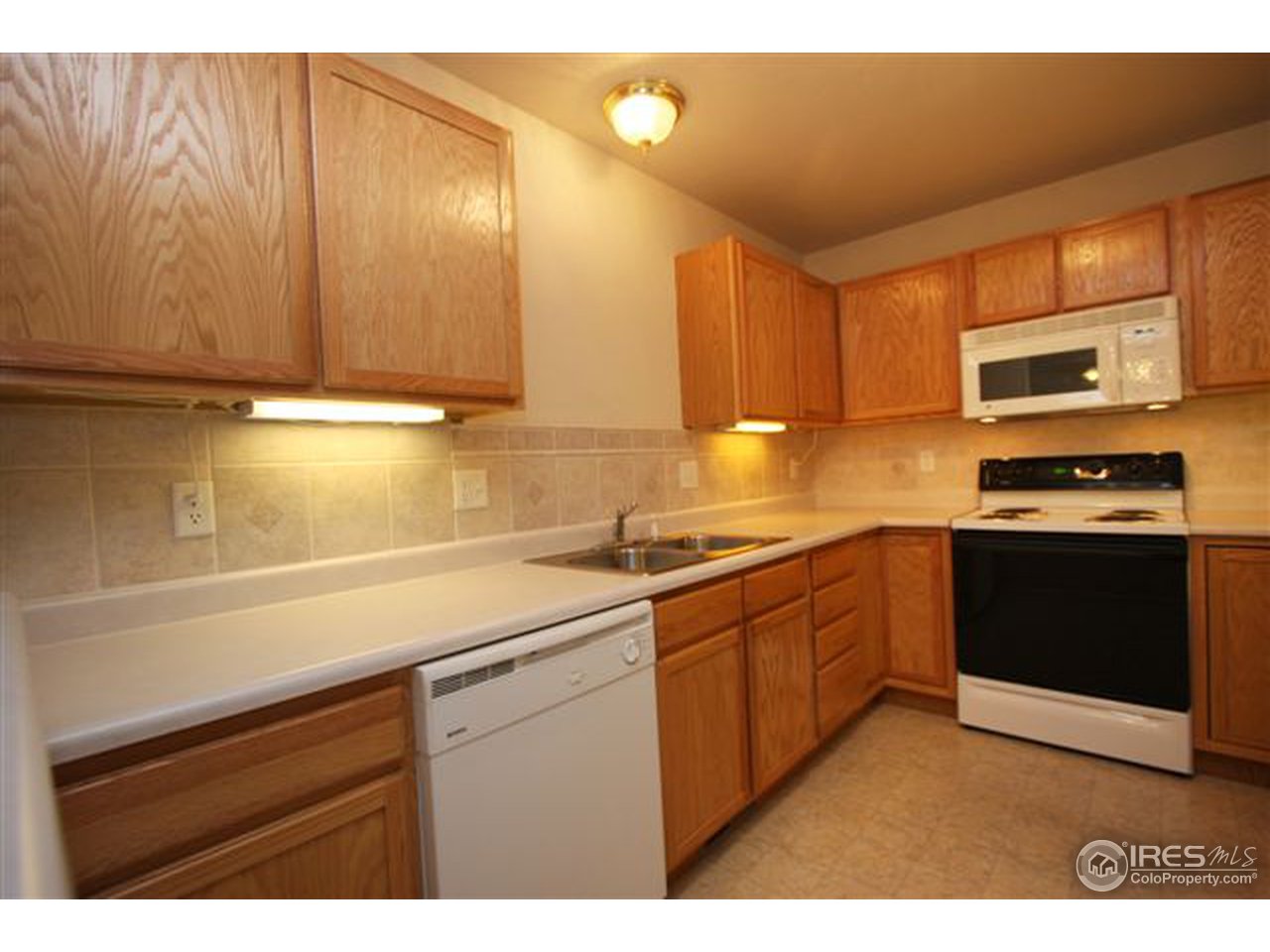 2621 Rigden Parkway, Unit C3 Fort Collins, CO 80525 - Photo 6 of 17 a kitchen with stainless steel appliances a sink stove and cabinets