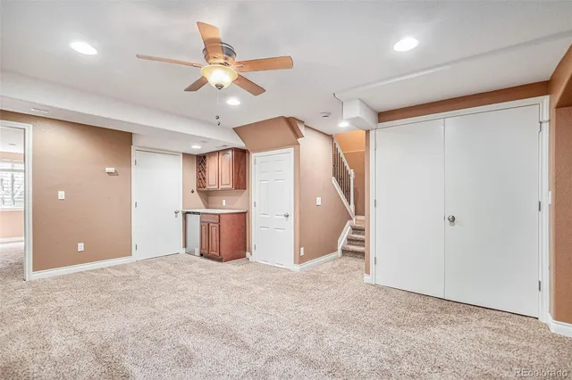a view of a kitchen with a sink and a ceiling fan