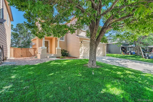 a front view of house with yard and green space
