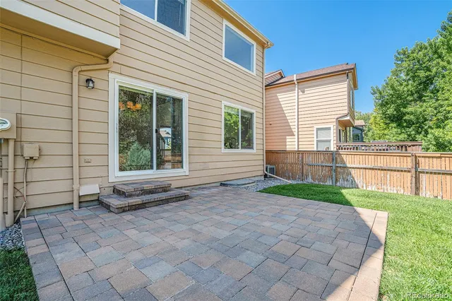 a view of a house with backyard and a garden