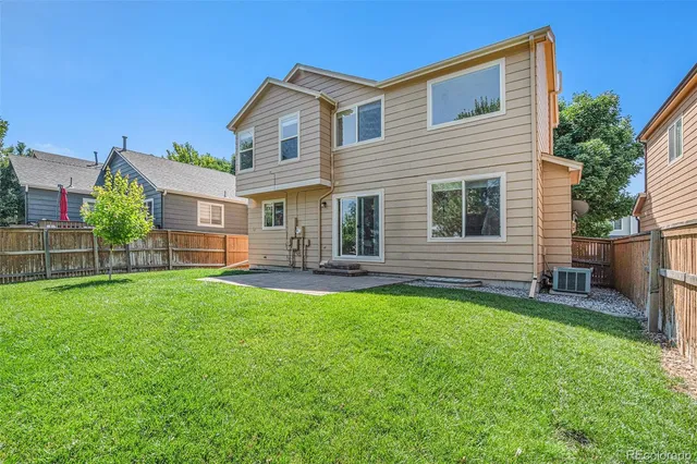 a view of a house with a backyard