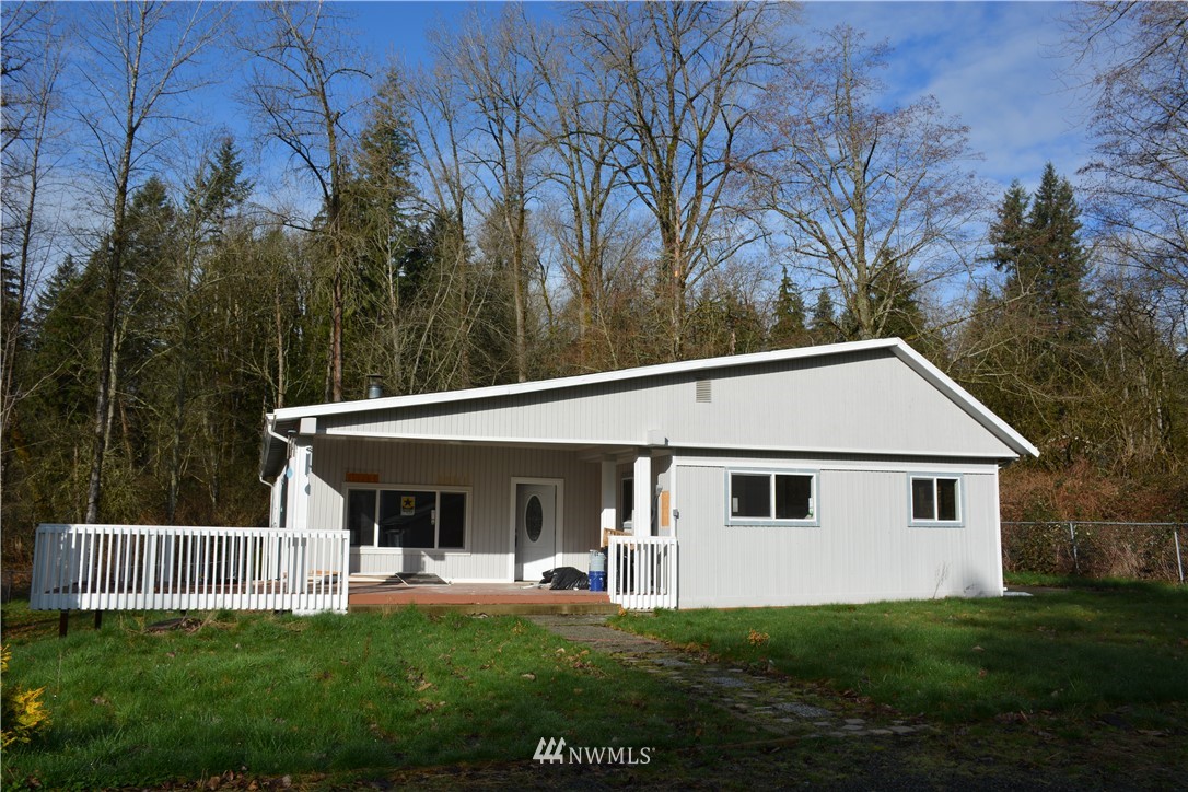 12606 Chain Lake Road Snohomish, WA 98290 - Photo 1 of 25 a view of a house with a yard and deck