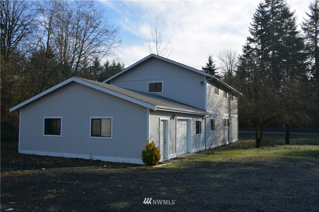 12606 Chain Lake Road Snohomish, WA 98290 - Photo 2 of 25 a front view of house with yard and trees