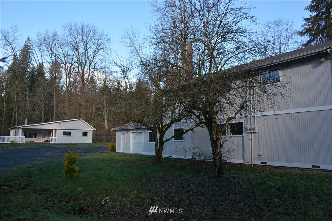 12606 Chain Lake Road Snohomish, WA 98290 - Photo 5 of 25 a view of house with backyard and garden