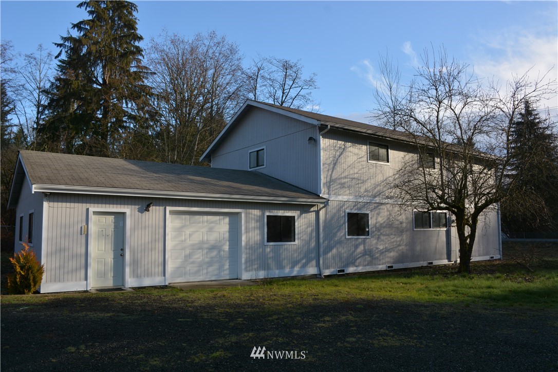 12606 Chain Lake Road Snohomish, WA 98290 - Photo 6 of 25 a front view of a house with a garden