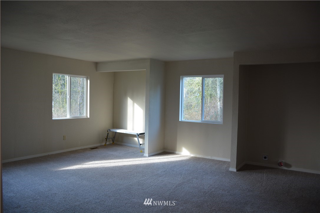 12606 Chain Lake Road Snohomish, WA 98290 - Photo 9 of 25 an empty room with windows