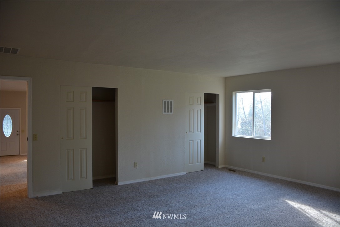 12606 Chain Lake Road Snohomish, WA 98290 - Photo 10 of 25 an empty room with windows