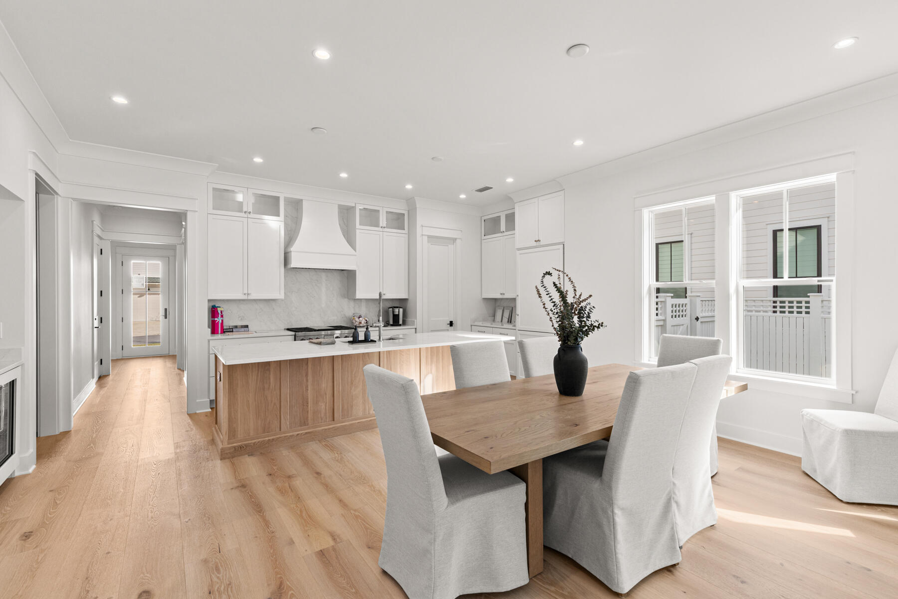 314 West Firethorn Circle, Unit LOT 33 Watersound, FL 32461 - Photo 2 of 32 a open kitchen with stainless steel appliances granite countertop a stove refrigerator and a dining table with wooden floor