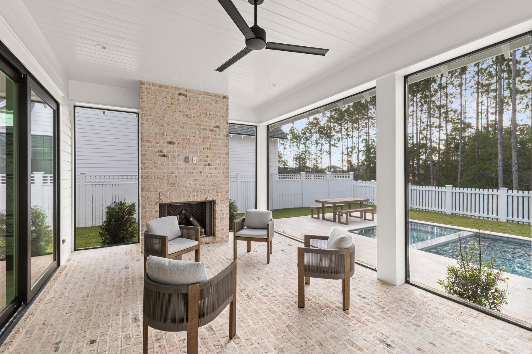 314 West Firethorn Circle, Unit LOT 33 Watersound, FL 32461 - Photo 7 of 32 a living room with fireplace furniture and a floor to ceiling window