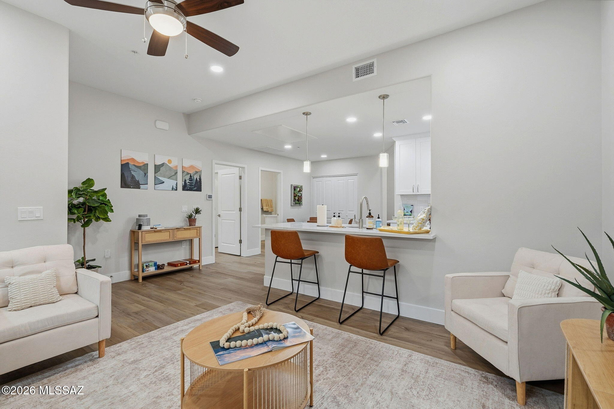 2020 East River Road, Unit 101 Tucson, AZ 85718 - Photo 2 of 12 a living room with furniture and a dining table with kitchen view