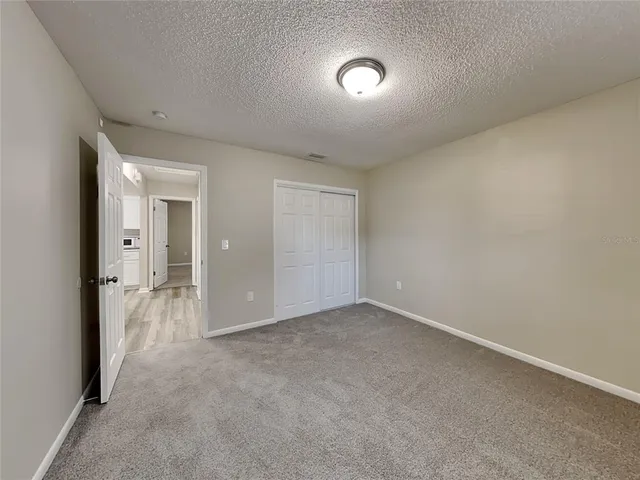 an empty room with a bathroom and a sink