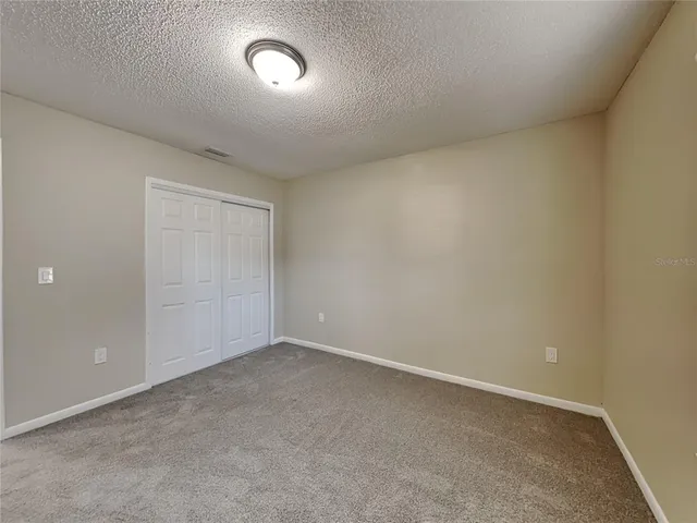 an empty room with a fan