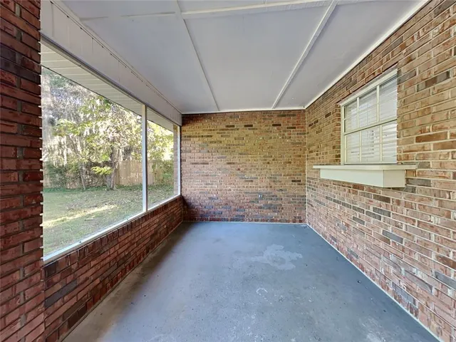 a view of a porch with wooden floor and outdoor space