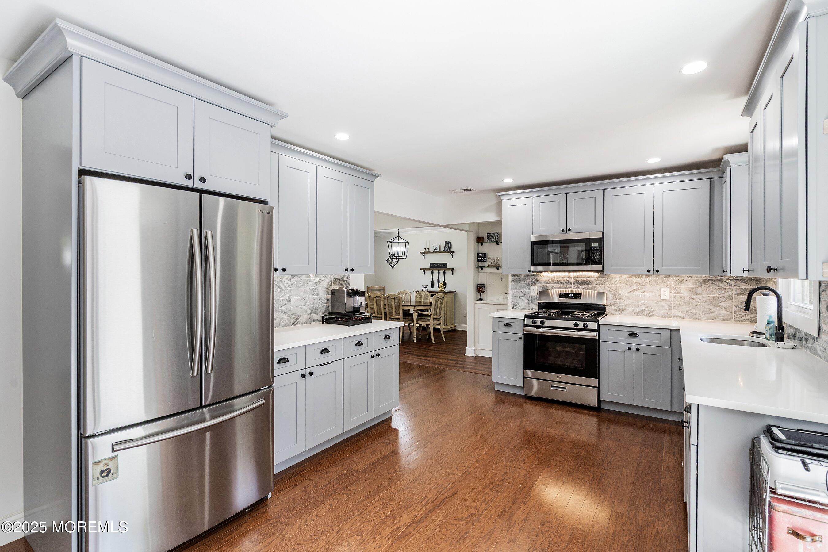 201 Paint Island Spring Road Millstone Township, NJ 08510 - Photo 5 of 34 a kitchen with stainless steel appliances a refrigerator sink and microwave