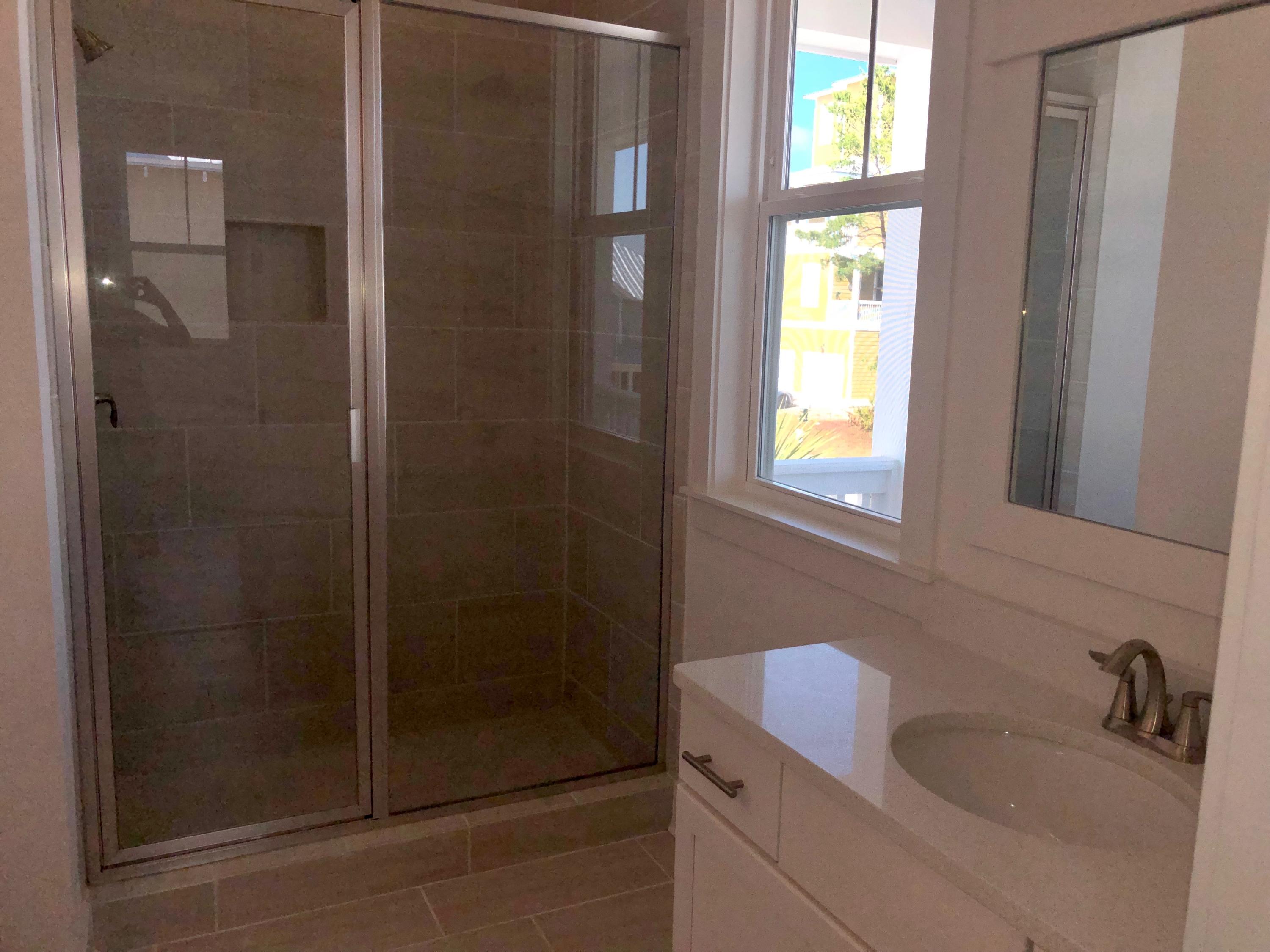 364 Grande Pointe Circle Inlet Beach, FL 32461 - Photo 15 of 33 a bathroom with a granite countertop sink a mirror and shower