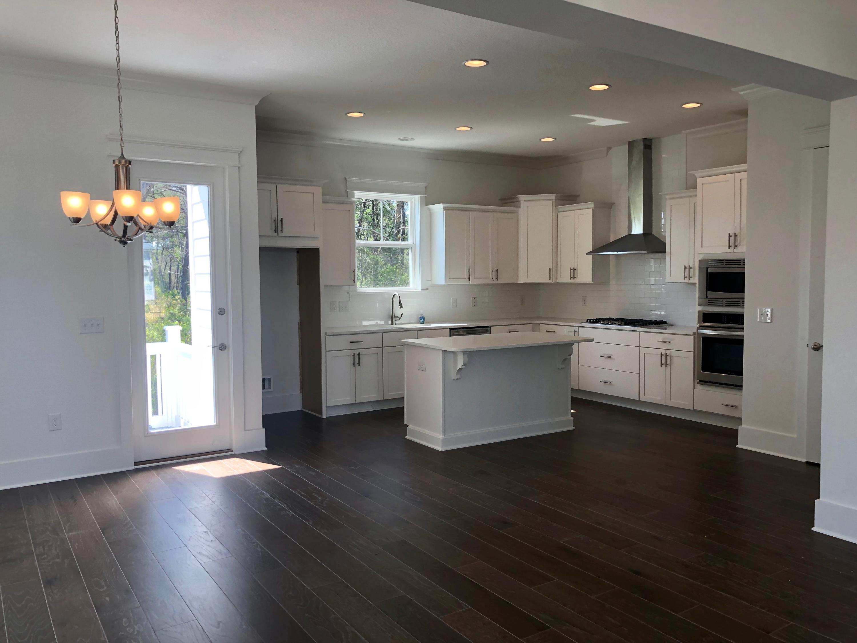 364 Grande Pointe Circle Inlet Beach, FL 32461 - Photo 5 of 33 a kitchen with stainless steel appliances granite countertop wooden floors and white cabinets
