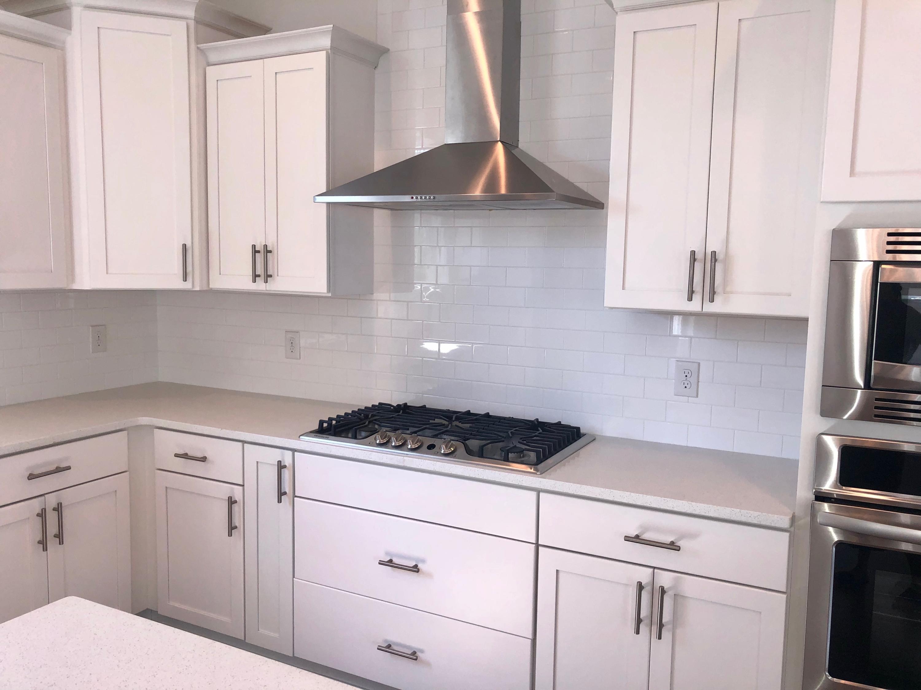 364 Grande Pointe Circle Inlet Beach, FL 32461 - Photo 6 of 33 a kitchen with white cabinets and a stove top oven
