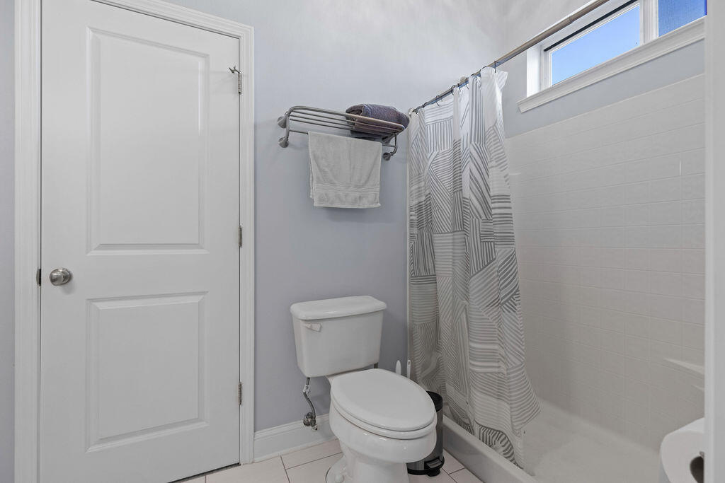 323 Main Street Destin, FL 32541 - Photo 18 of 43 a white toilet sitting next to a shower