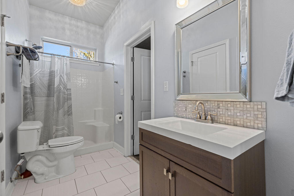 323 Main Street Destin, FL 32541 - Photo 19 of 43 a bathroom with a sink toilet double vanity and shower