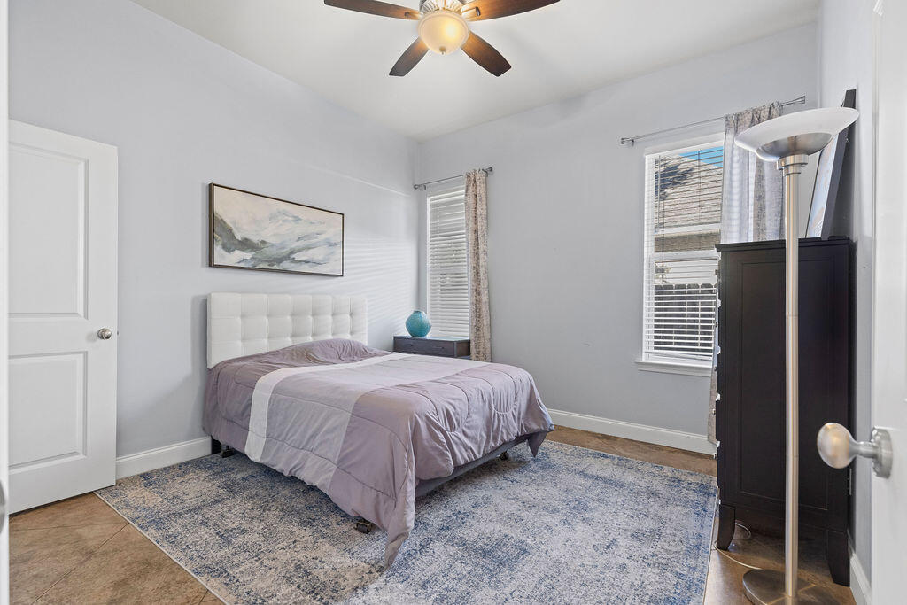 323 Main Street Destin, FL 32541 - Photo 21 of 43 a bedroom with a bed and a painting on the wall