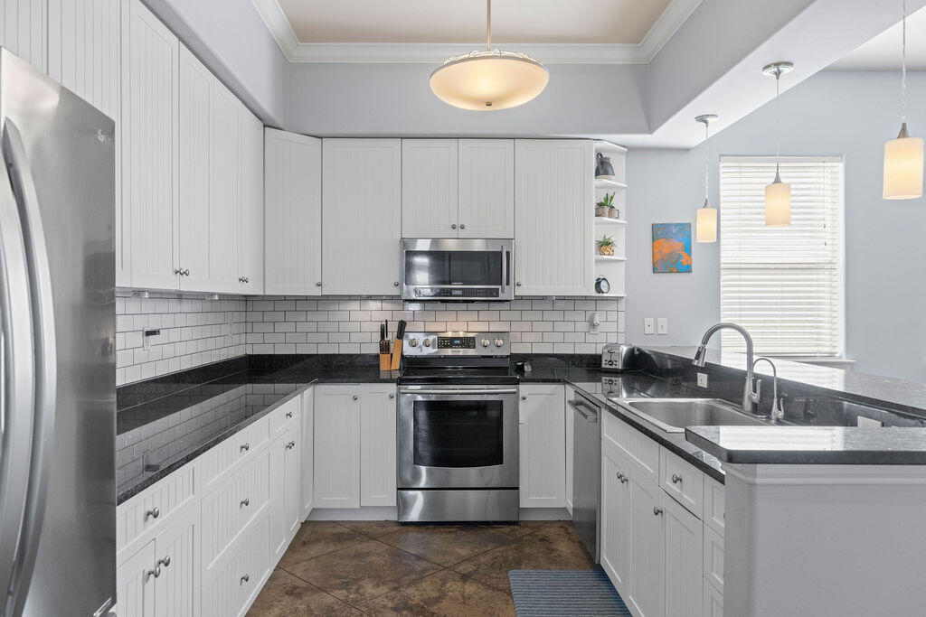 323 Main Street Destin, FL 32541 - Photo 27 of 43 a kitchen with stainless steel appliances granite countertop a sink stove and refrigerator
