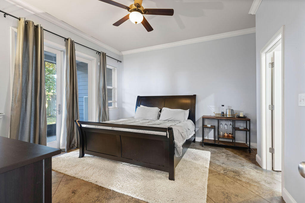 323 Main Street Destin, FL 32541 - Photo 34 of 43 a bedroom with a bed and a chandelier