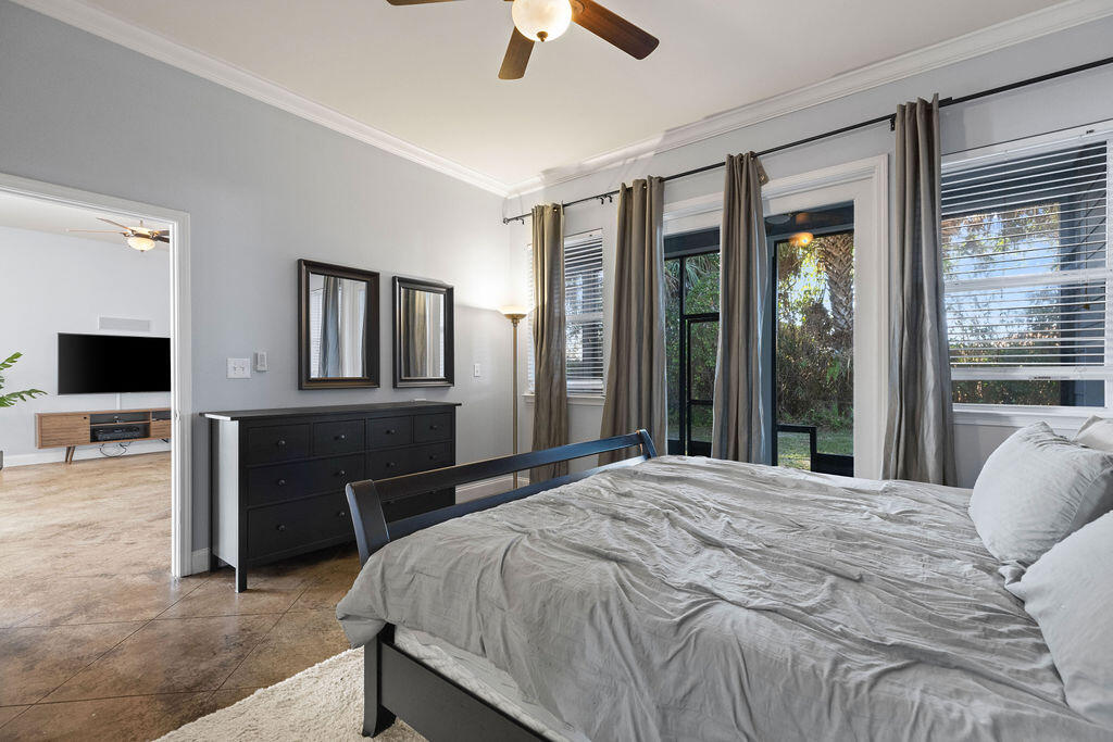 323 Main Street Destin, FL 32541 - Photo 35 of 43 a bedroom with a bed and a chandelier