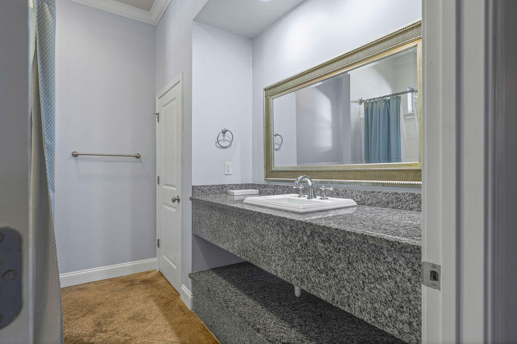 323 Main Street Destin, FL 32541 - Photo 36 of 43 a bathroom with a granite countertop sink and a mirror