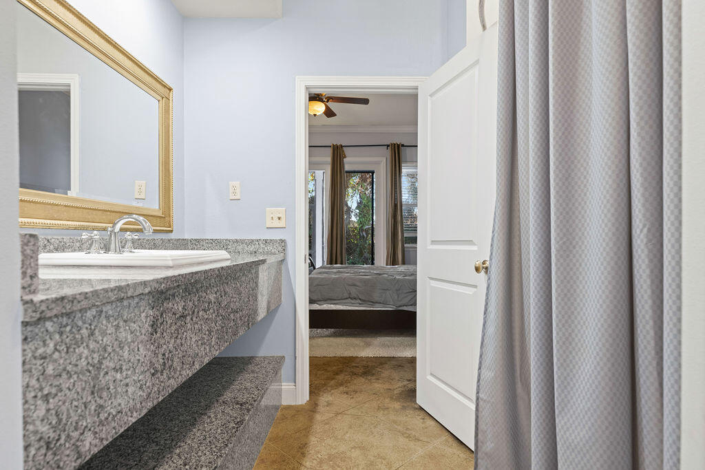 323 Main Street Destin, FL 32541 - Photo 38 of 43 a bathroom with a granite countertop sink and a mirror