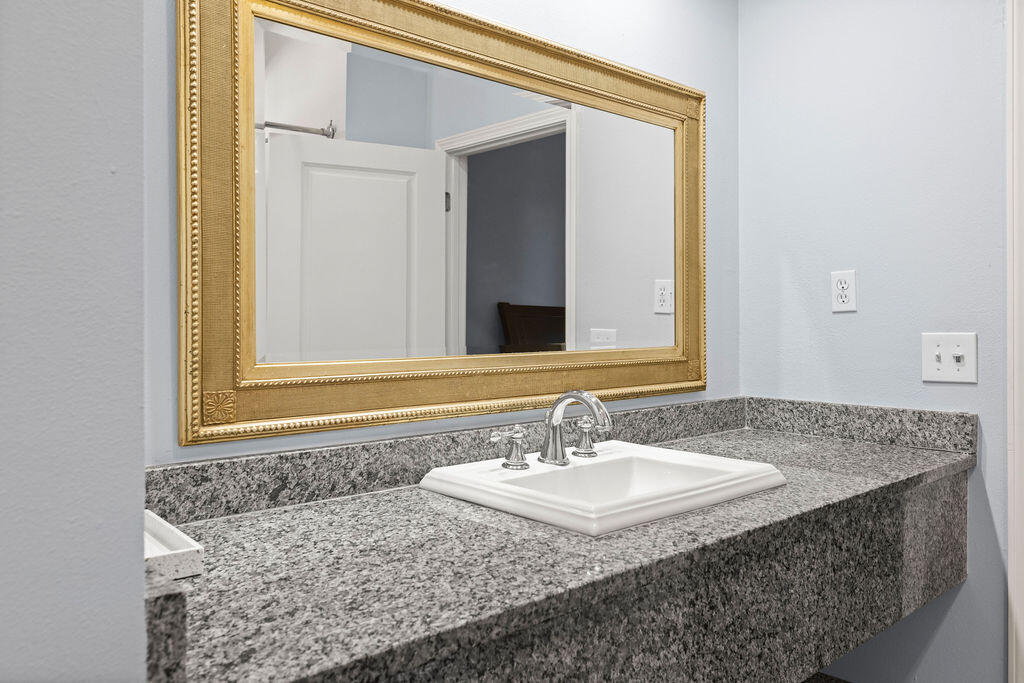 323 Main Street Destin, FL 32541 - Photo 39 of 43 a bathroom with a granite countertop sink and a mirror