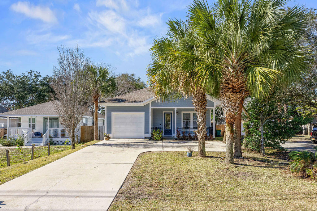 323 Main Street Destin, FL 32541 - Photo 4 of 43 a front view of a house with a yard