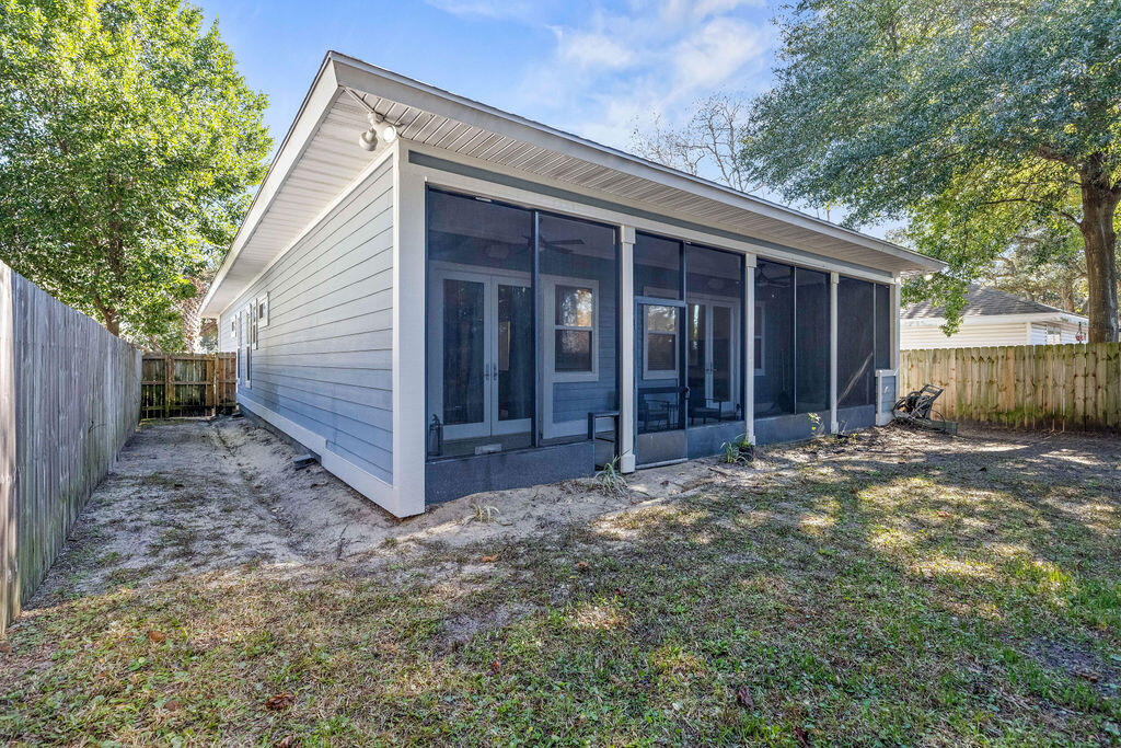 323 Main Street Destin, FL 32541 - Photo 10 of 43 a view of a house with a yard and wooden fence
