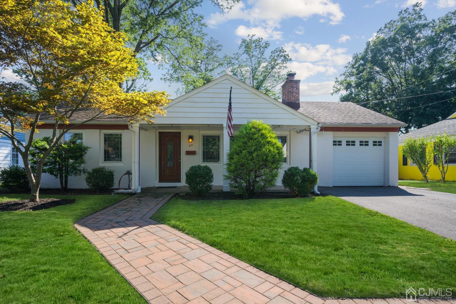a front view of a house with a yard and porch