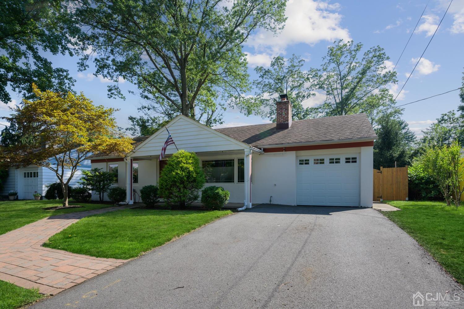 49 George Avenue Middlesex, NJ 08846 - Photo 2 of 20 a front view of a house with a garden and trees