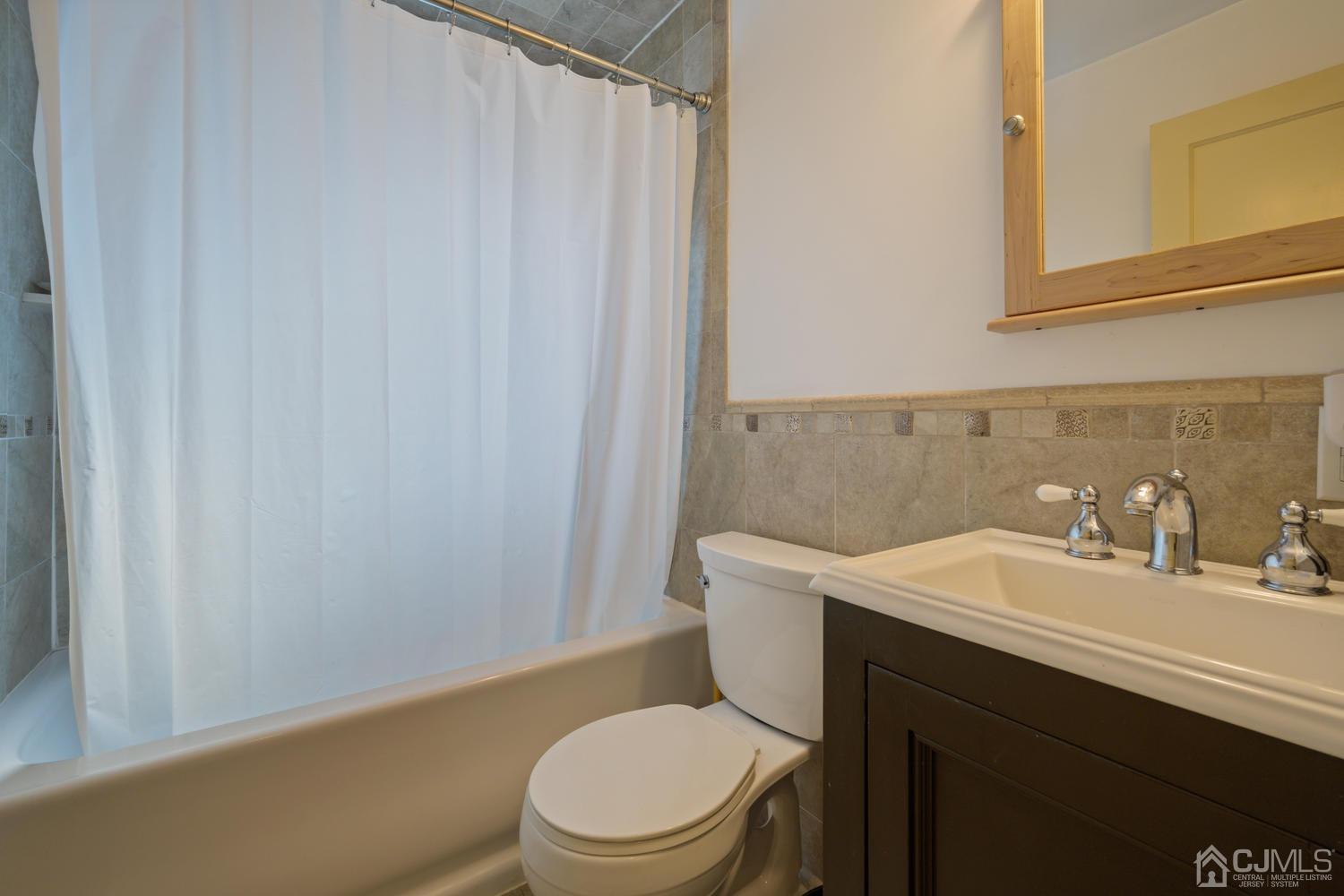 49 George Avenue Middlesex, NJ 08846 - Photo 17 of 20 a bathroom with a sink a toilet and shower