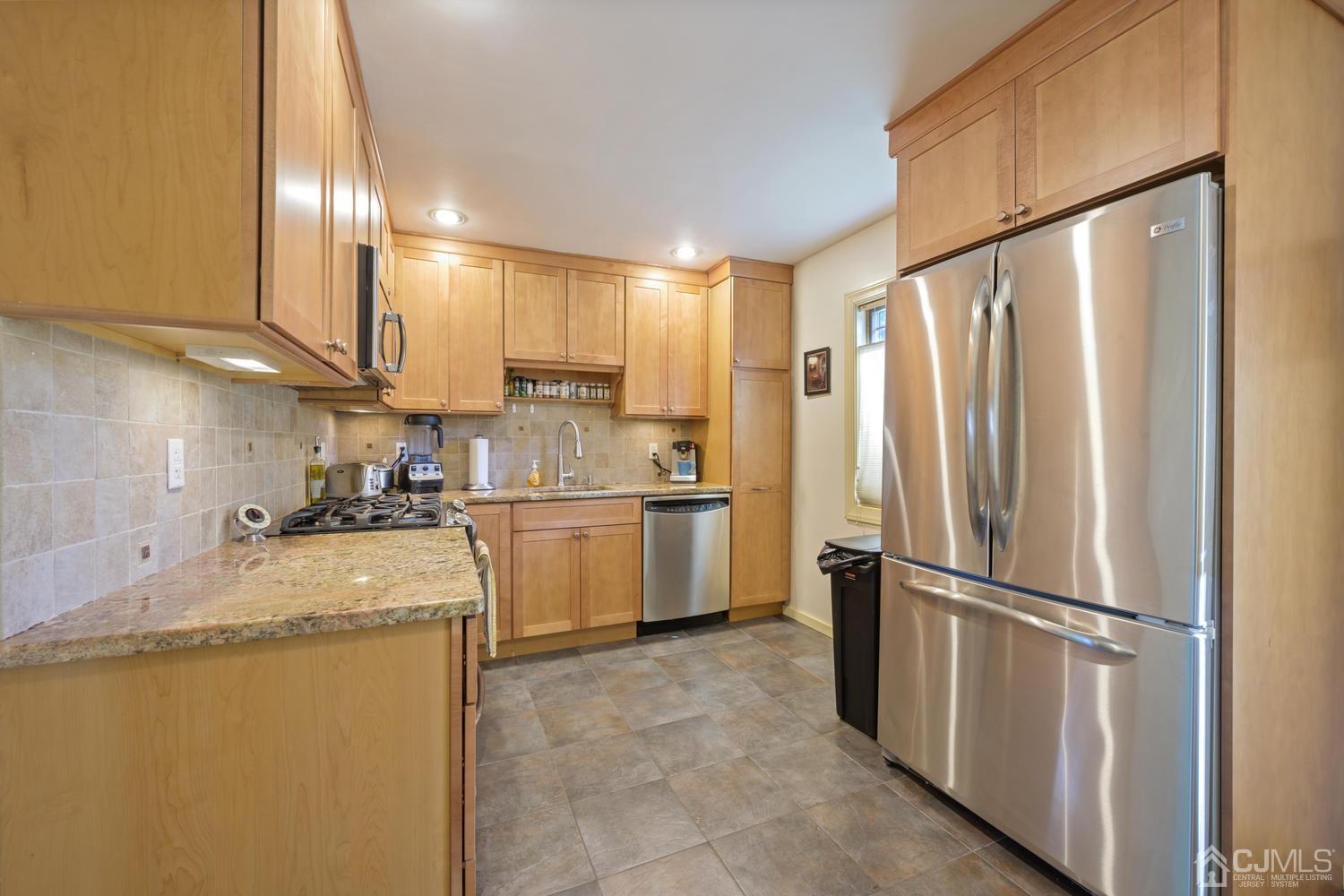 49 George Avenue Middlesex, NJ 08846 - Photo 8 of 20 a kitchen with a refrigerator a sink and cabinets