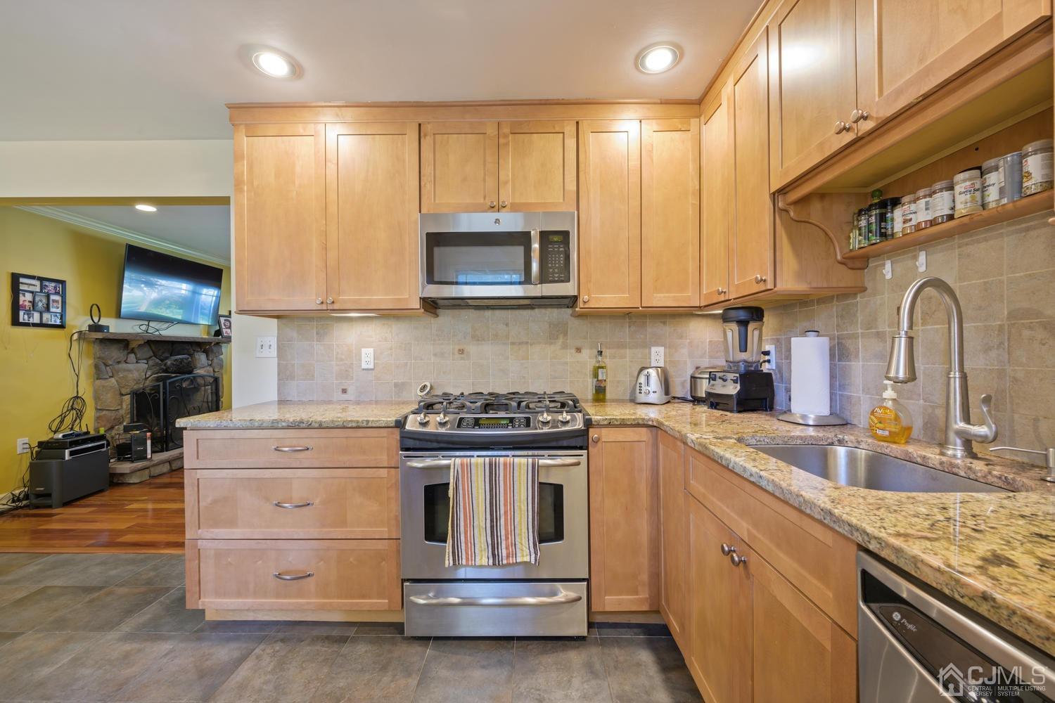 49 George Avenue Middlesex, NJ 08846 - Photo 10 of 20 a kitchen with stainless steel appliances granite countertop a stove and a sink