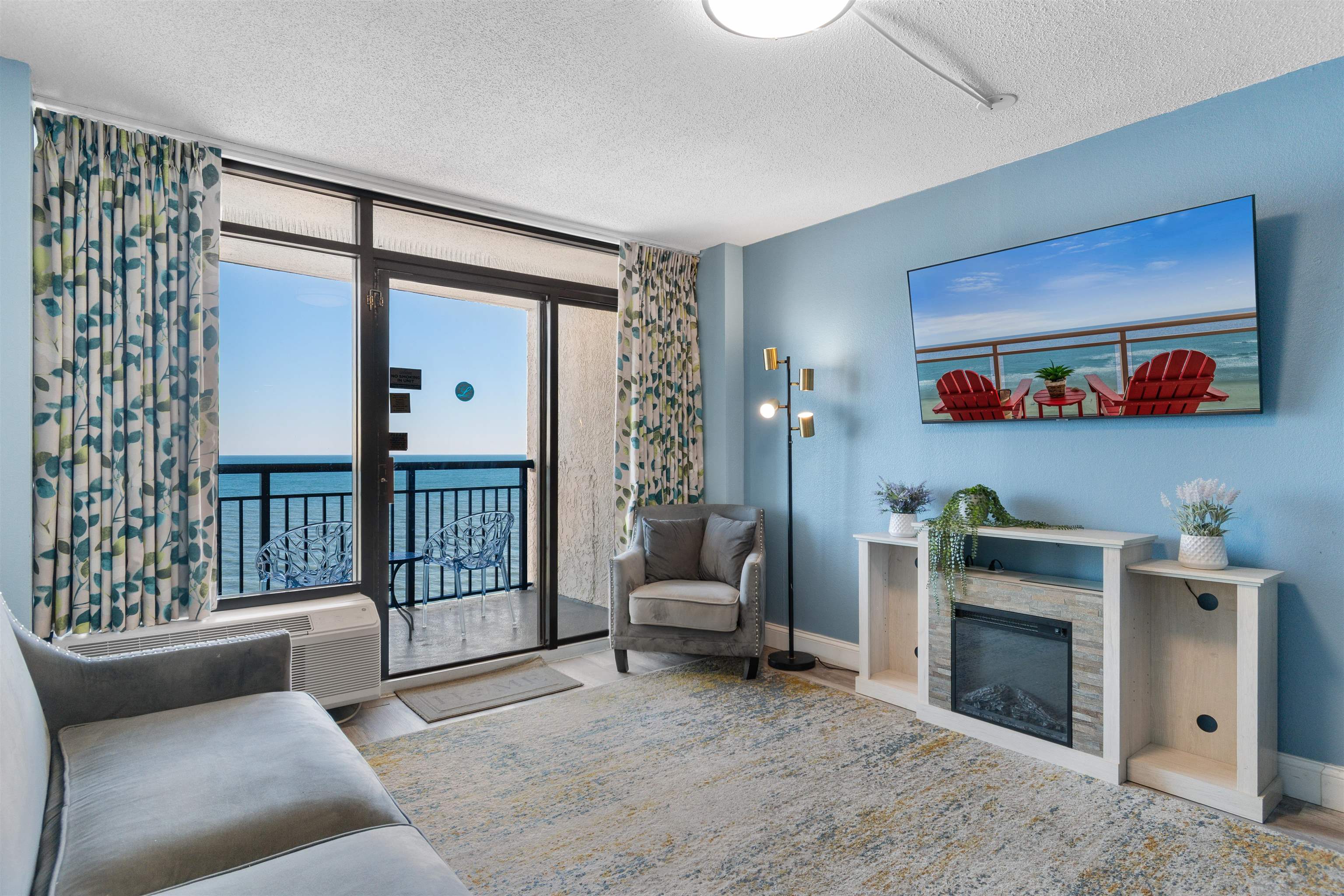 1501 South Ocean Boulevard, Unit 1237 Myrtle Beach, SC 29577 - Photo 16 of 40 Living area featuring a textured ceiling, wood finished floors, and expansive windows