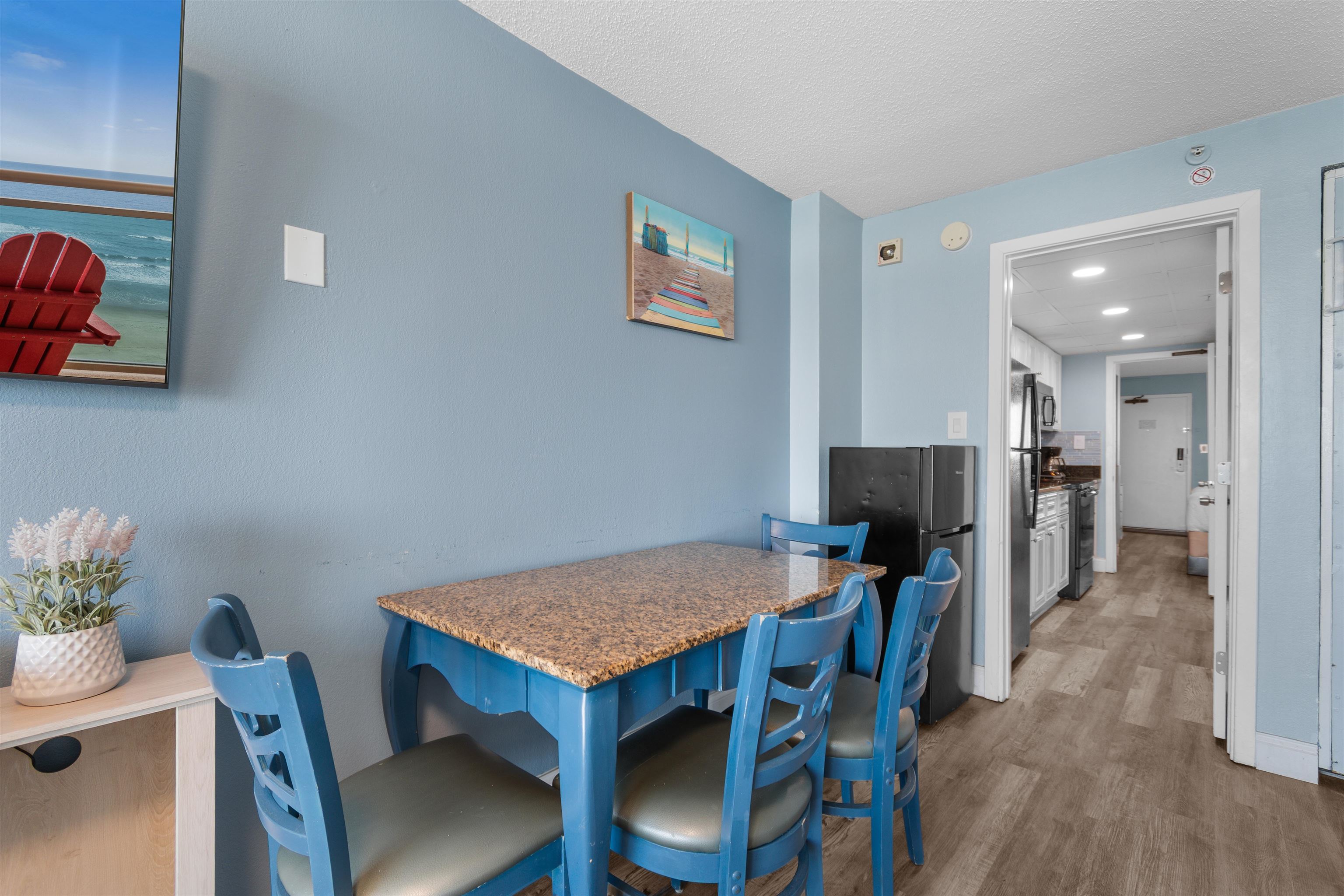 1501 South Ocean Boulevard, Unit 1237 Myrtle Beach, SC 29577 - Photo 17 of 40 Dining room with a textured ceiling and wood finished floors