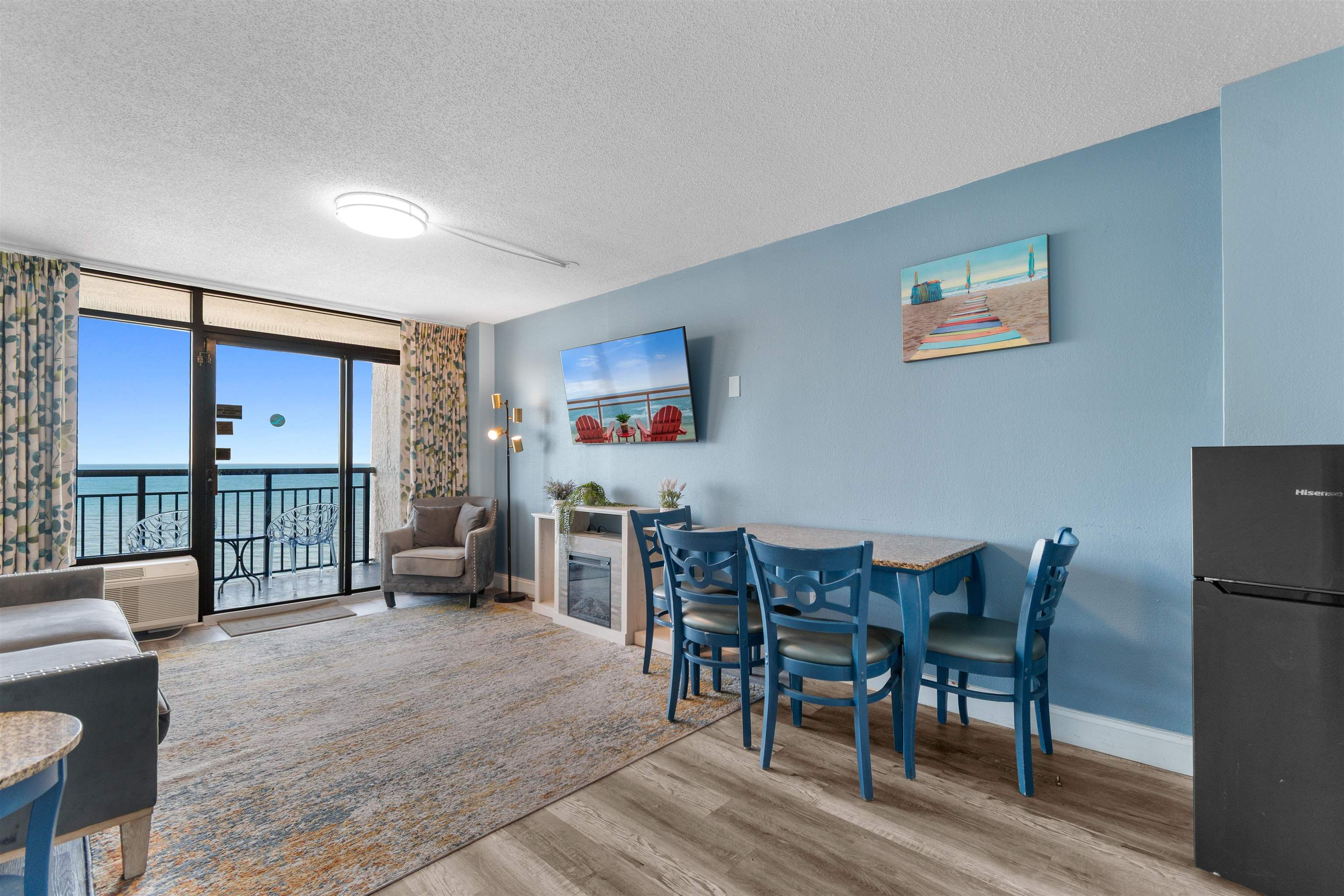 1501 South Ocean Boulevard, Unit 1237 Myrtle Beach, SC 29577 - Photo 19 of 40 Dining space with a textured ceiling, light wood finished floors, and a wall of windows