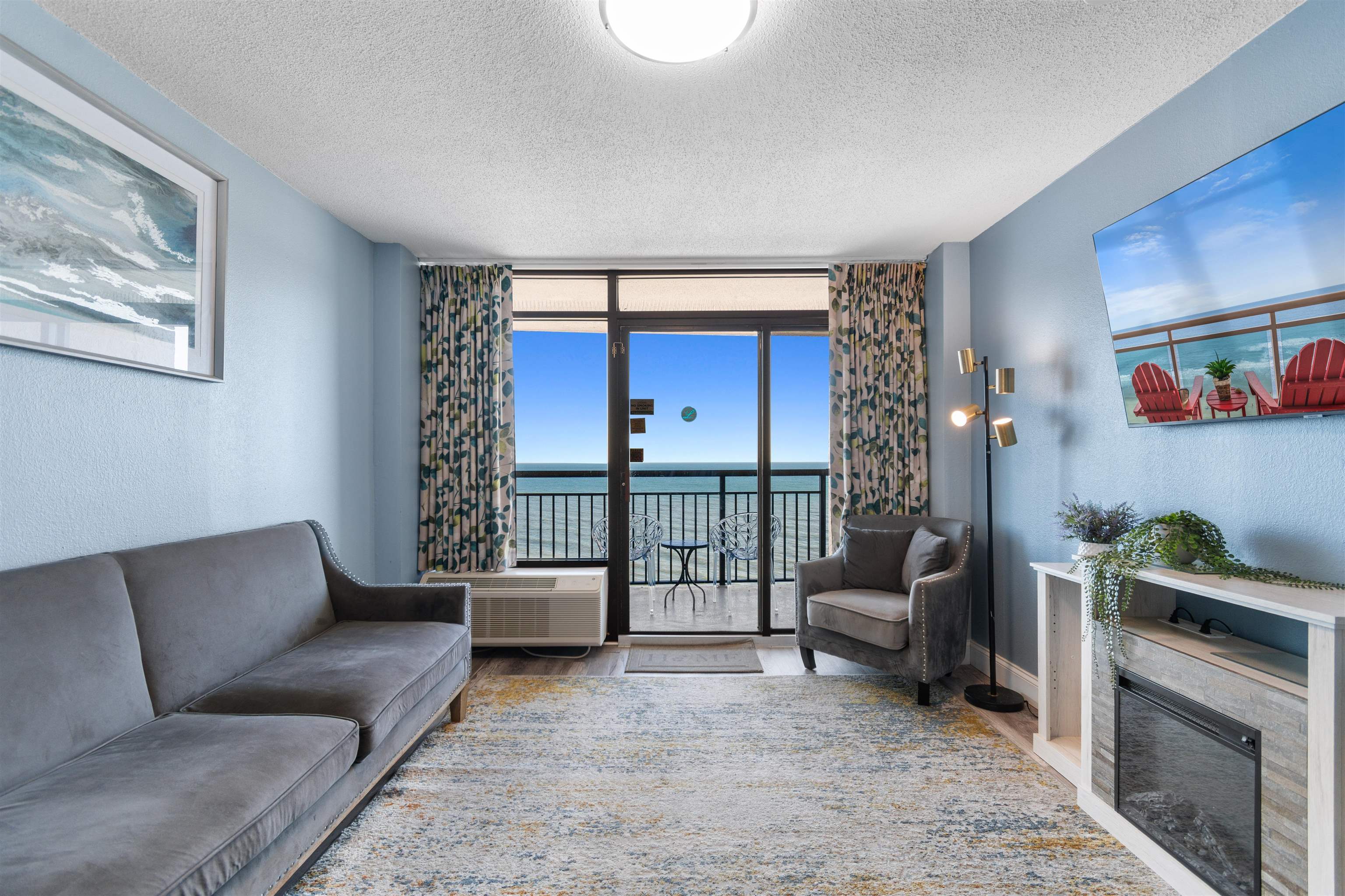 1501 South Ocean Boulevard, Unit 1237 Myrtle Beach, SC 29577 - Photo 21 of 40 Living area with expansive windows, a textured ceiling, wood finished floors, and a textured wall
