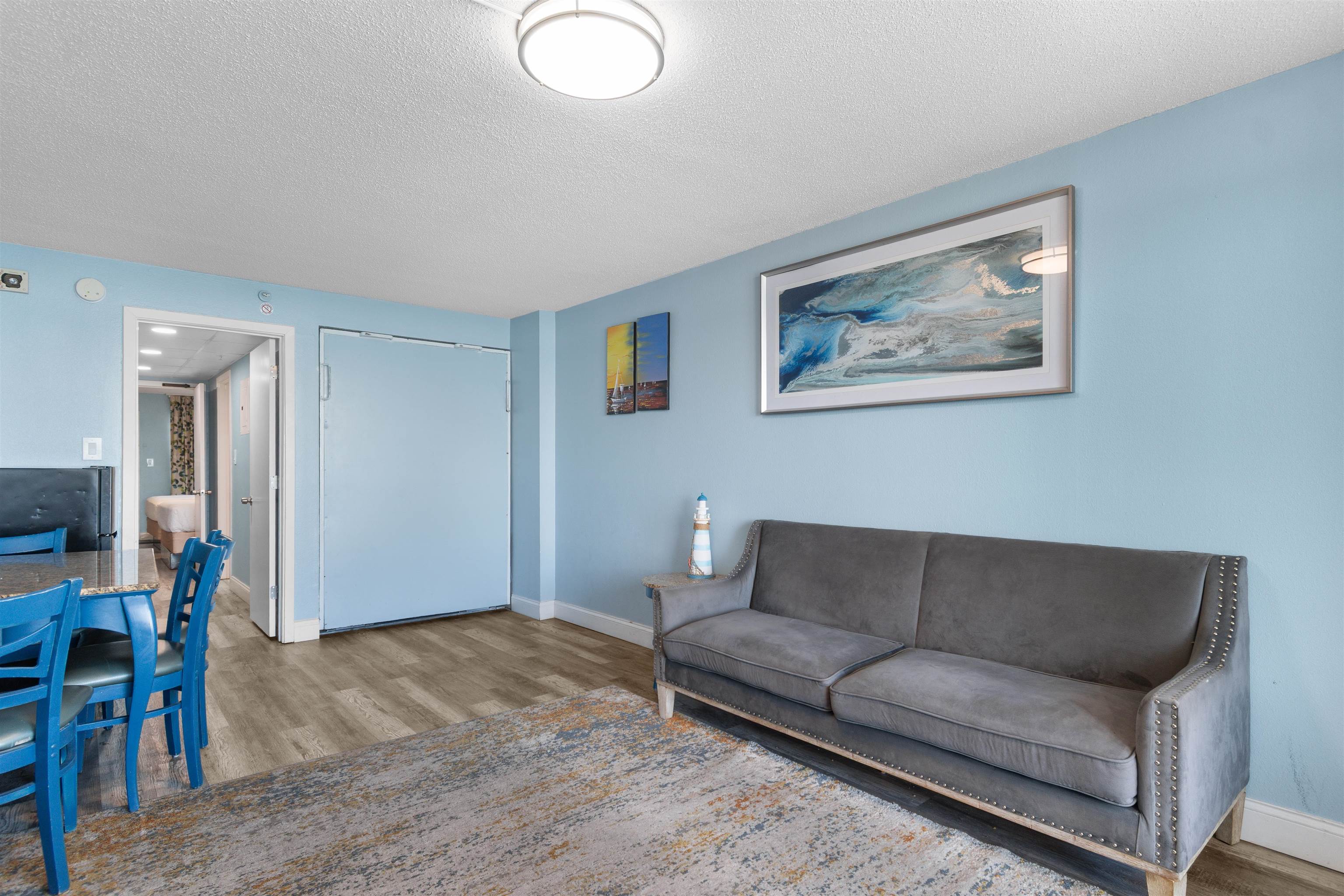 1501 South Ocean Boulevard, Unit 1237 Myrtle Beach, SC 29577 - Photo 27 of 40 Living room featuring a textured ceiling and wood finished floors