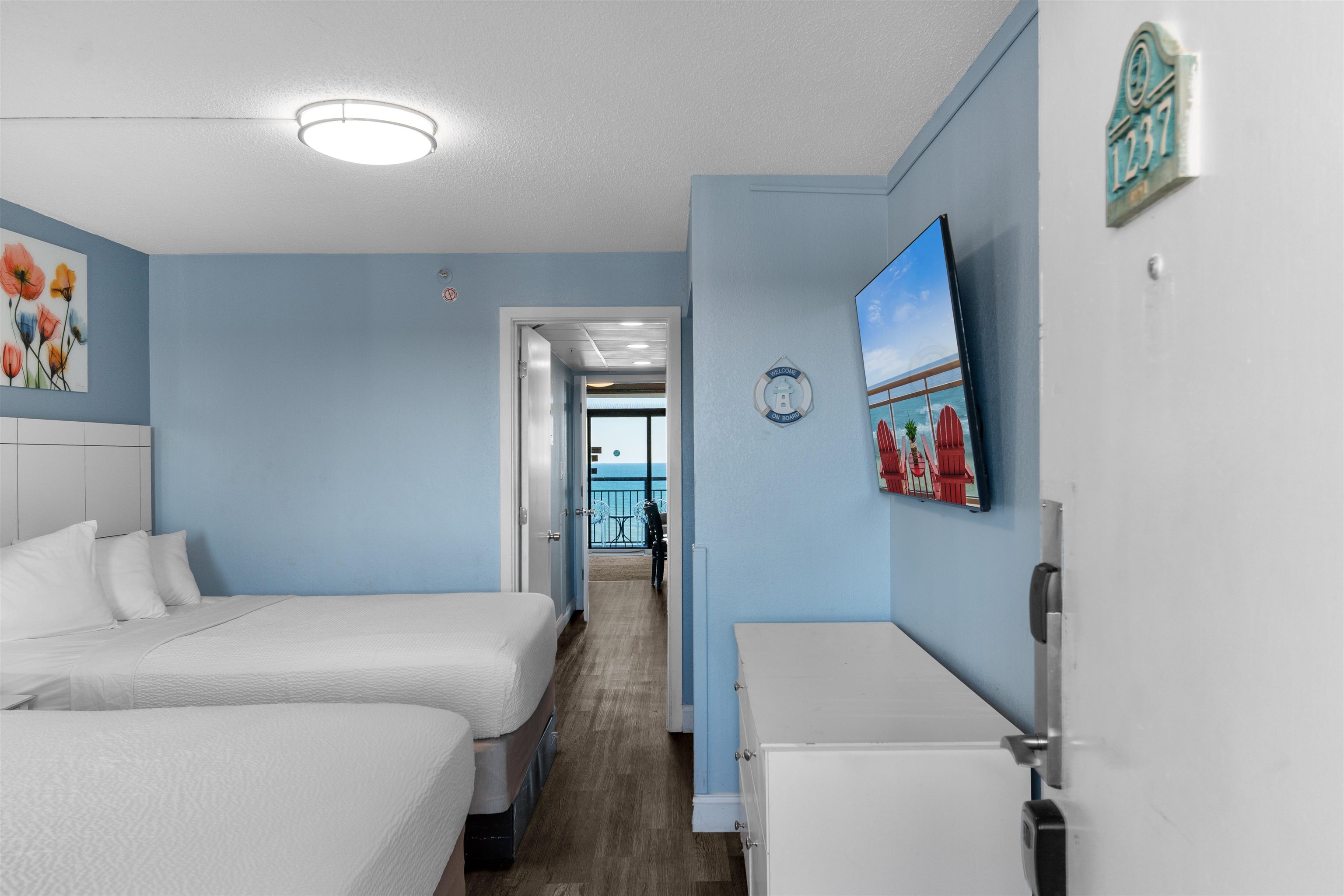 1501 South Ocean Boulevard, Unit 1237 Myrtle Beach, SC 29577 - Photo 6 of 40 Bedroom with a textured ceiling and dark wood-style floors