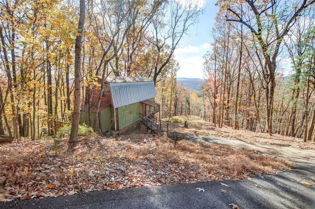a backyard of a house with lots of trees